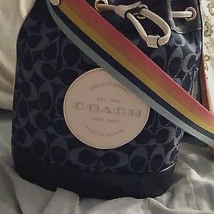Coach purse its navy with the white coach on the front with a rainbow strip